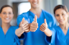 Dental team giving thumbs ups