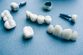 Different types of dental implants in Buzzards Bay on blue background