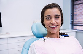 young woman smiling after getting dental implants in Buzzards Bay