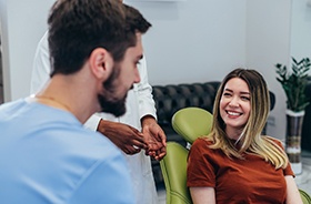 Dentist and patient conversing in treatment room