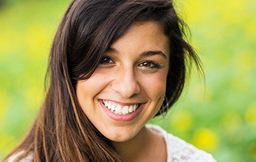 Young woman with flawless smile outdoors
