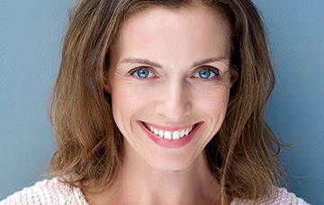 Woman in white sweater smiling