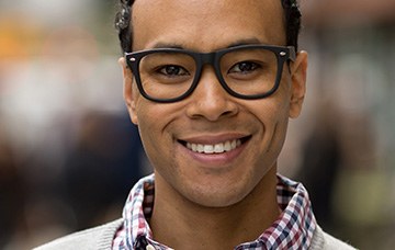 Smiling man wearing glasses outdoors