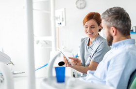 Patient and dentist discussing cost of gum recontouring