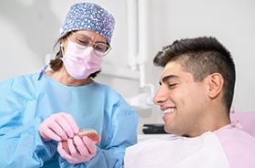 Dentist and patient talking about Invisalign treatment