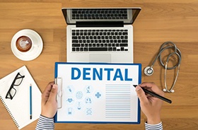 Clipboard with dental information viewed from above