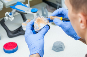 Dental lab technician working on dentures