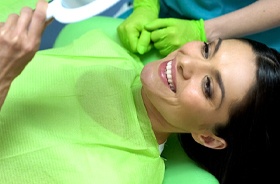 happy dental patient with mirror