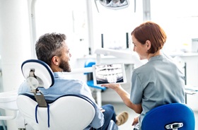 Patient at dental checkup, reviewing his X-Ray results
