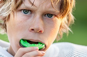 Teen boy placing sportsguard