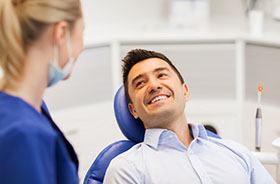 Relaxed dental patient learning about the cost of his treatment