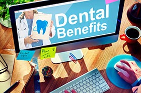 Person using computer to look up information about dental benefits