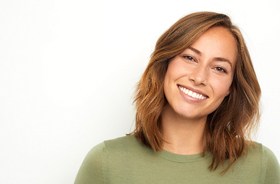 Woman with gorgeous teeth enjoying benefits of smile makeover