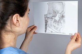 Dental professional looking at image of patient’s TMJs