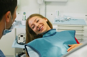 Dentist and patient discussing need for tooth-colored fillings