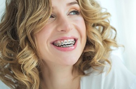 Smiling blond woman with traditional braces in Buzzards Bay