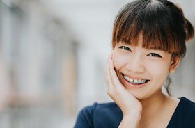 Smiling woman, happy she could afford the cost of traditional braces in Buzzards Bay