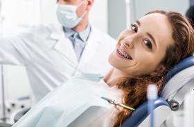 Happy female patient at orthodontic checkup appointment