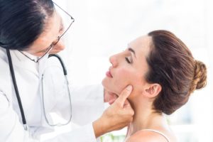Woman visiting medical professional for jaw pain on one side