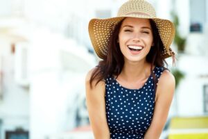 Beautiful, smiling woman wearing a sun hat